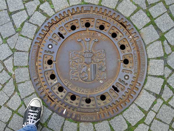 manhole cover near marktplatz in leipzig, germany on august 22, 2019