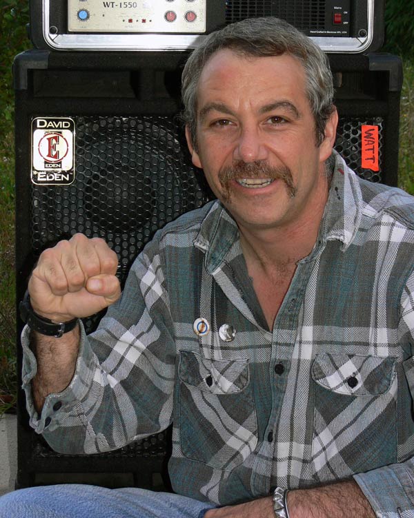 mike watt self-portrait (using autotimer) in front of his amp in front of his prac pad in san pedro, ca on november 1, 2005