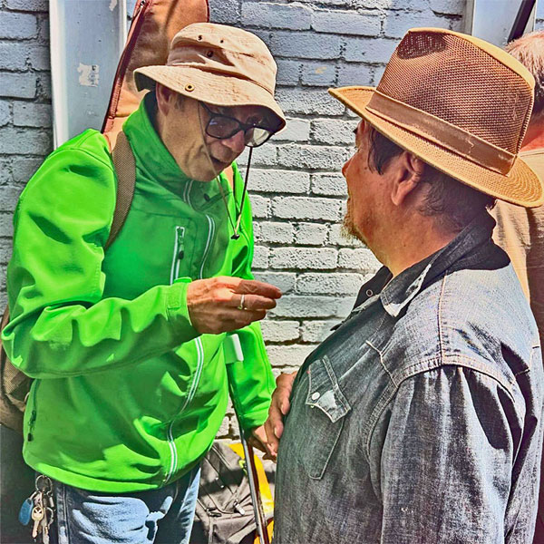 mike watt talking to joe baiza in the lot behind 'harlow's' in santa moncia, ca on july 14, 2024 - photo by jordan schwartz mike watt talking to joe baiza in the lot behind 'harlow's' in santa moncia, ca on july 14, 2024 - photo by jordan schwartz