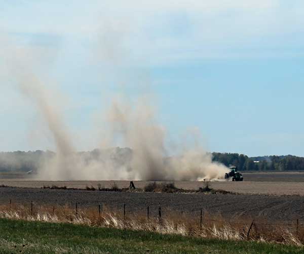 tractor kickin up much dust on the side of the I-5 going south on way to cave junction, or on september 12, 2023