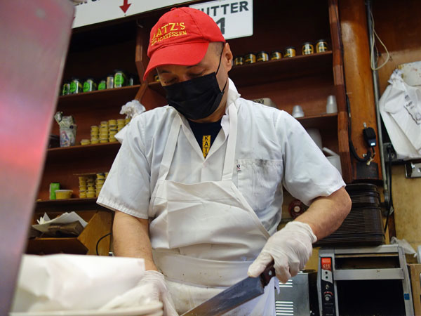 cutter preparing chopped liver sandwich for watt at katz's in manhattan, ny