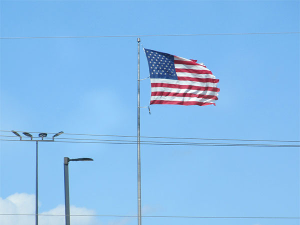 u.s. flag getting whupped up big time by a buttload of wind in dinwiddie, in